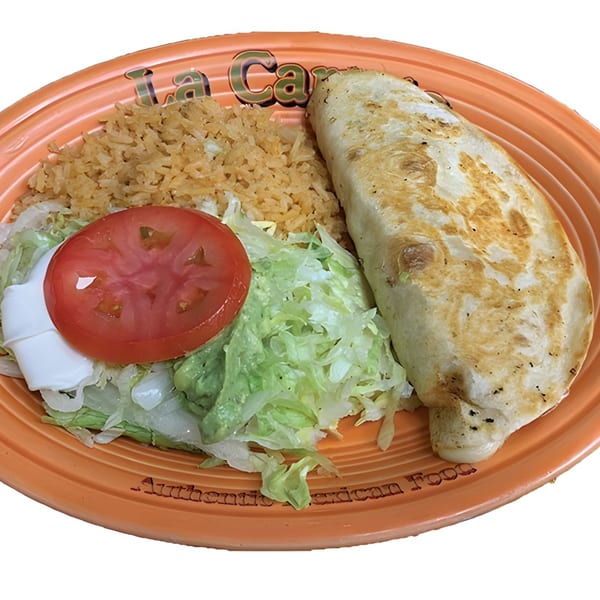 A La Carreta Mexican Restaurant plate with a quesadilla, rice, lettuce, tomato, and sour cream.