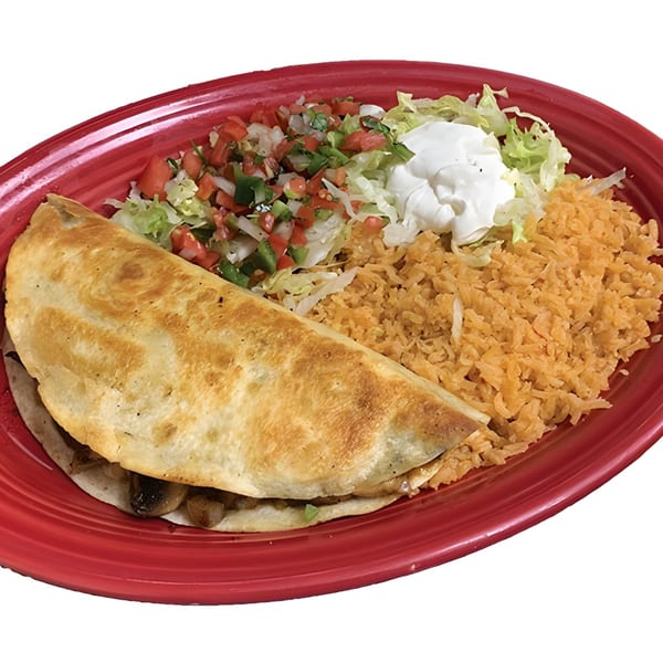A quesadilla with rice, pico de gallo, shredded lettuce, and sour cream on a red plate.