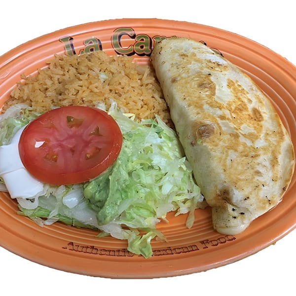 A La Carreta Mexican Restaurant plate with a quesadilla, rice, lettuce, tomato, and sour cream.