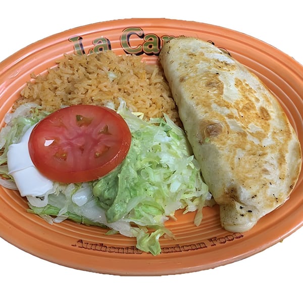 A La Carreta Mexican Restaurant plate with a burrito, rice, lettuce, tomato, sour cream, and guacamole.