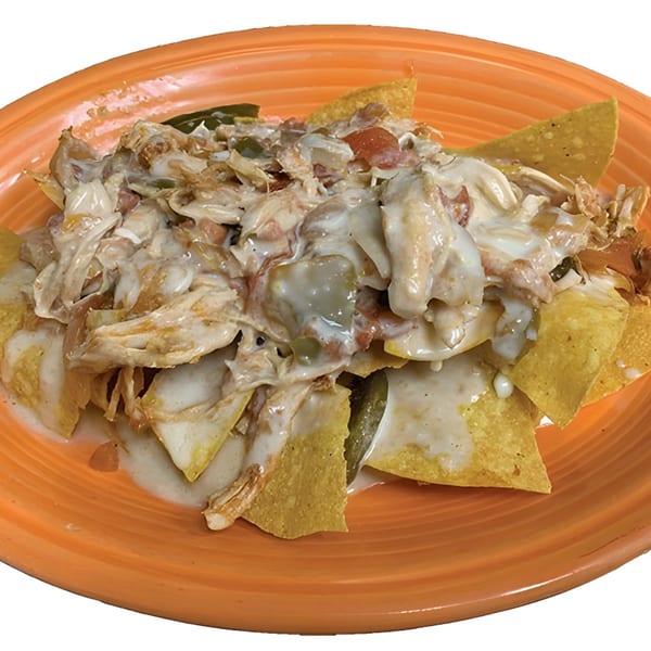 La Carreta's chicken nachos, topped with creamy white sauce, diced tomatoes, and green peppers.