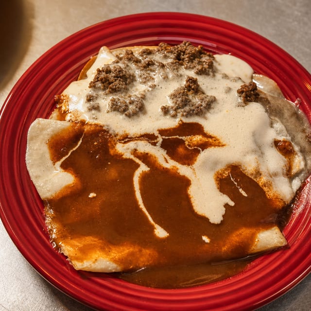 25. One Beef Burrito Topped with Cheese Dip, One Beef Enchilada & One Beef Chile Con Queso.